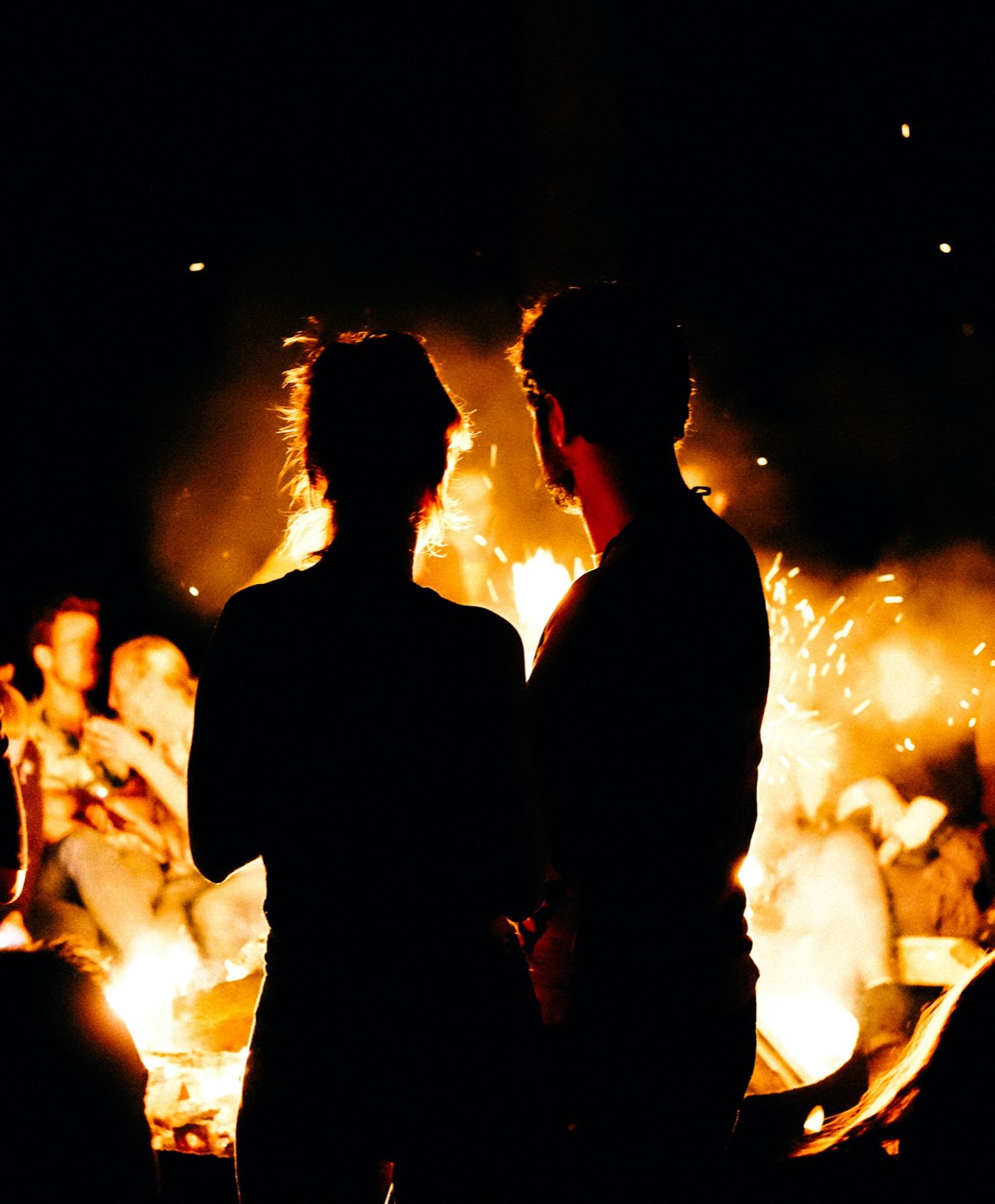 Friends around a fire at night